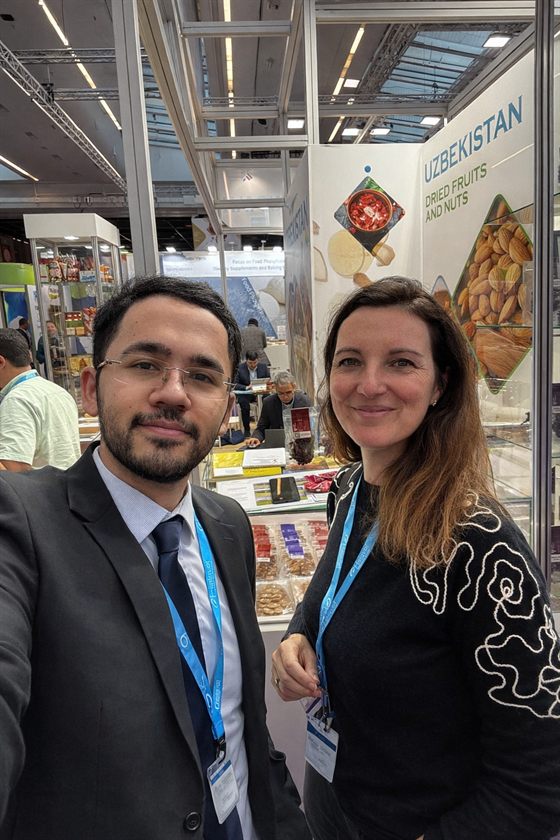 An NNP Raisins colleague with a visitor at the Uzbekistan pavilion at Fi Europe 2025 in Paris.